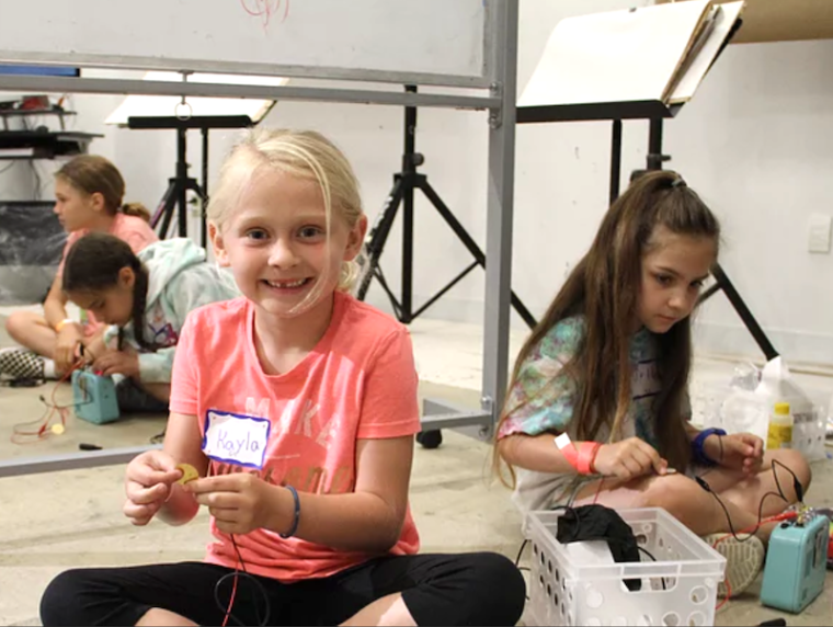 young girls playing with electrical projects