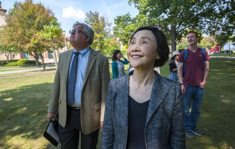 Tomoko Watanabe walks with Gavin Tritt and others in Tappan Square
