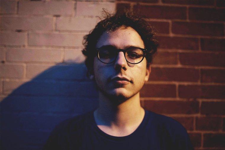 Headshot of Griffin Jennings against a brick wall 