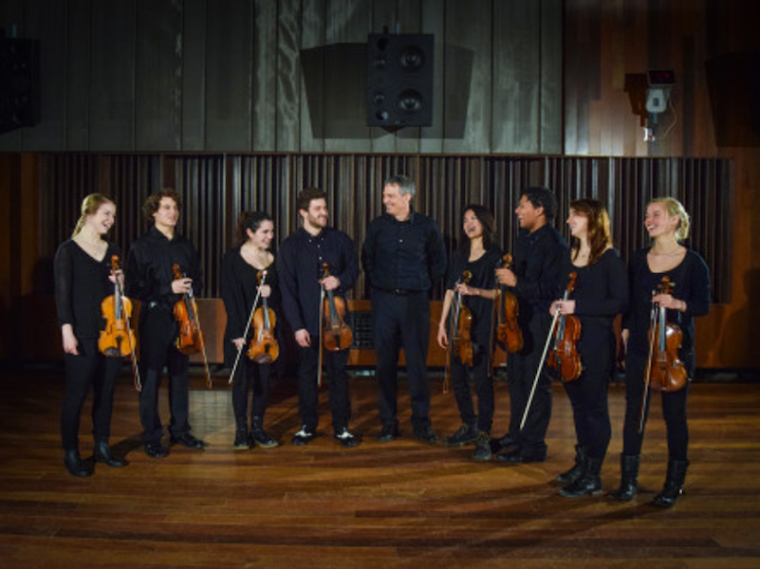 eight violinists with their conductor.