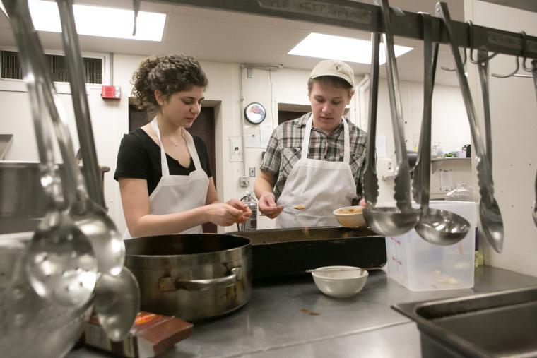 Students serving a meal in Harkness coop 
