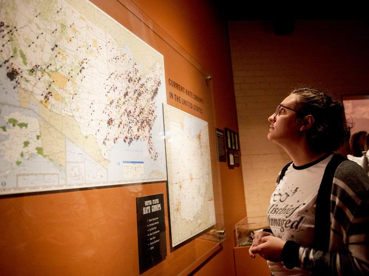 student looks at map mounted on wall.