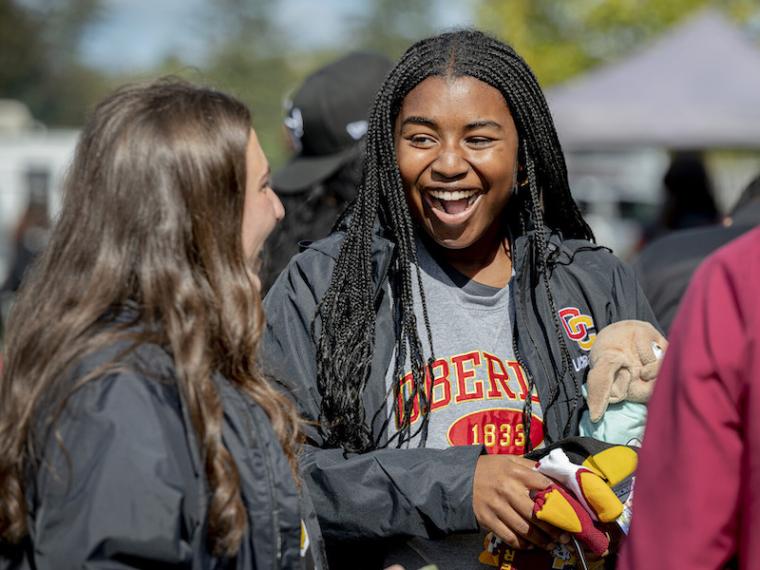 Students laughing at a homecoming event.