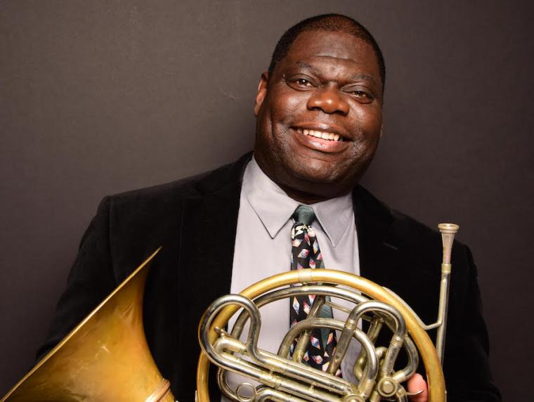 horn professor Jeff Scott holding his french horn.