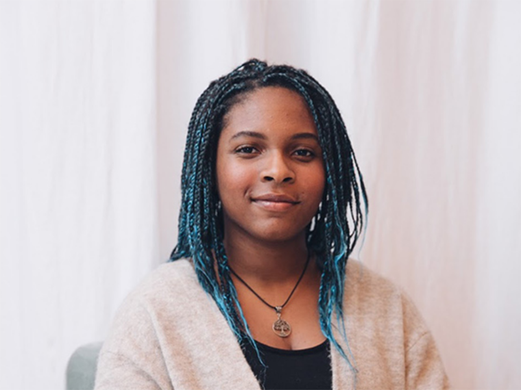 back woman sitting on a chair.