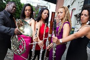 The four members of Imani Winds including Oberlin alumni Toyin Spellman-Diaz ’94 holding an oboe and Monica Ellis ’95 holding a bassoon