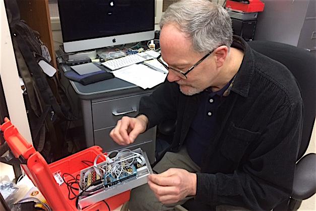 John Talbert inspects wires in an electronic component