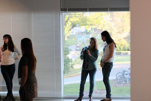 A photographer and student look at the screen on a camera