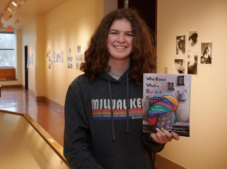 Student Isabel Pfaff holding a book