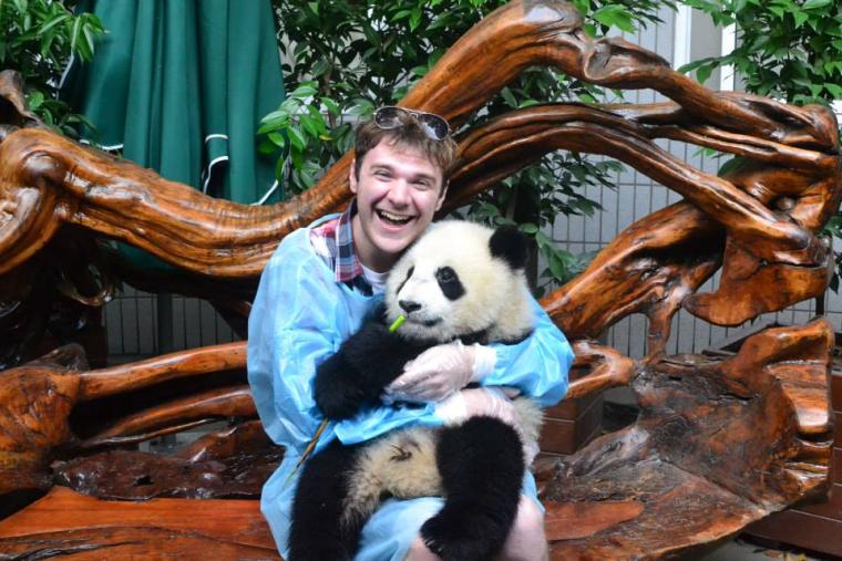 Jacob Myers holds a baby panda