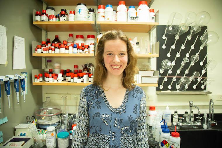 woman standing in chemistry lab.