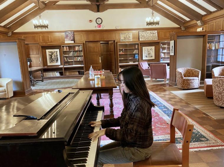 piano student practicing in Asia House lounge.