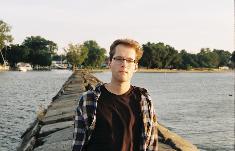 young man Josh Augustin standing on pier