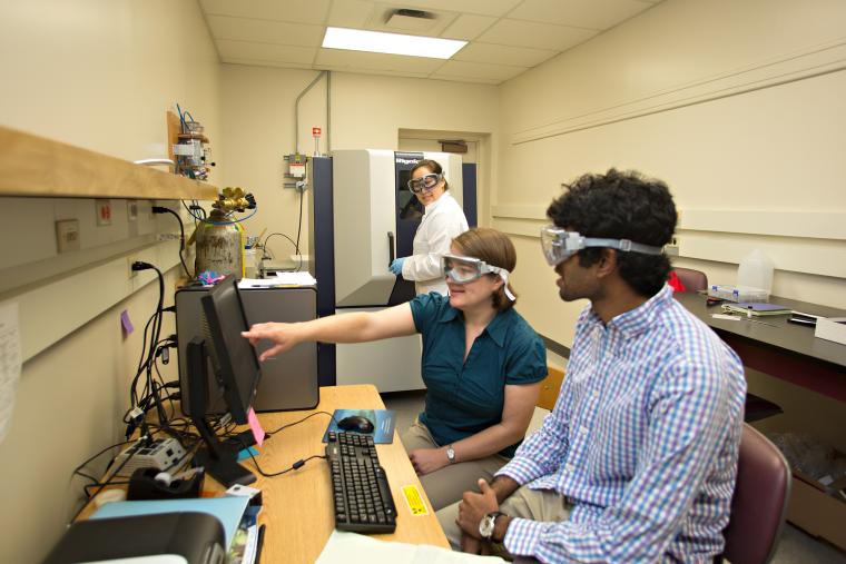 Professor and students in a lab.
