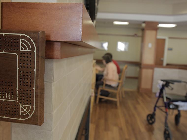 Two people seated in front of a computer at a retirement community.