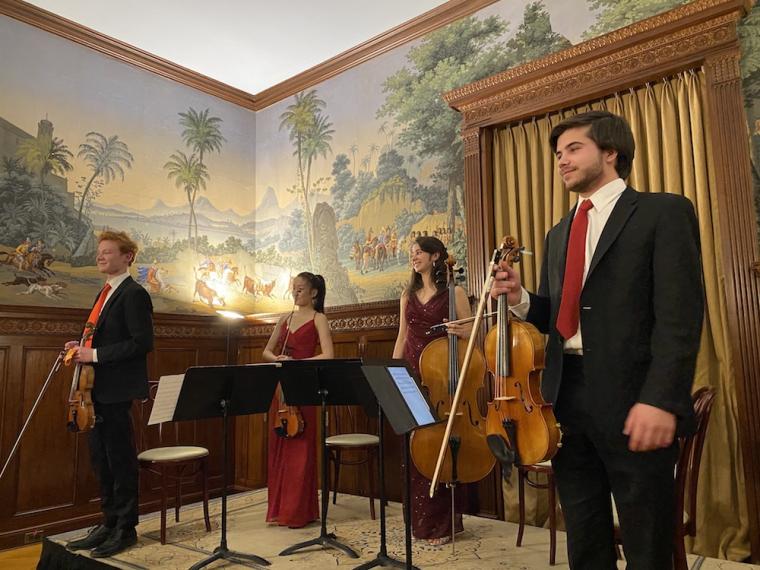 four members of a student string quartet take a bow.