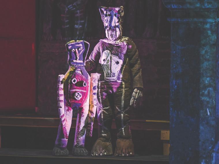 two puppets standing next to each other on stage