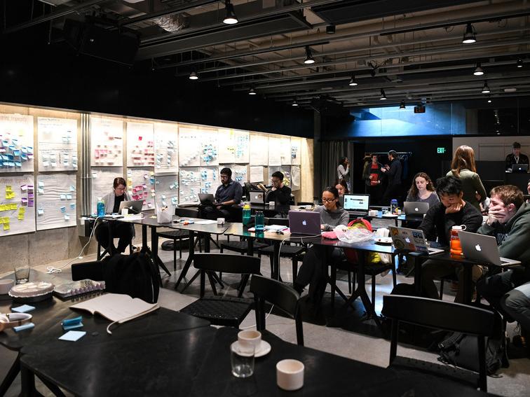 people working in a room with computers