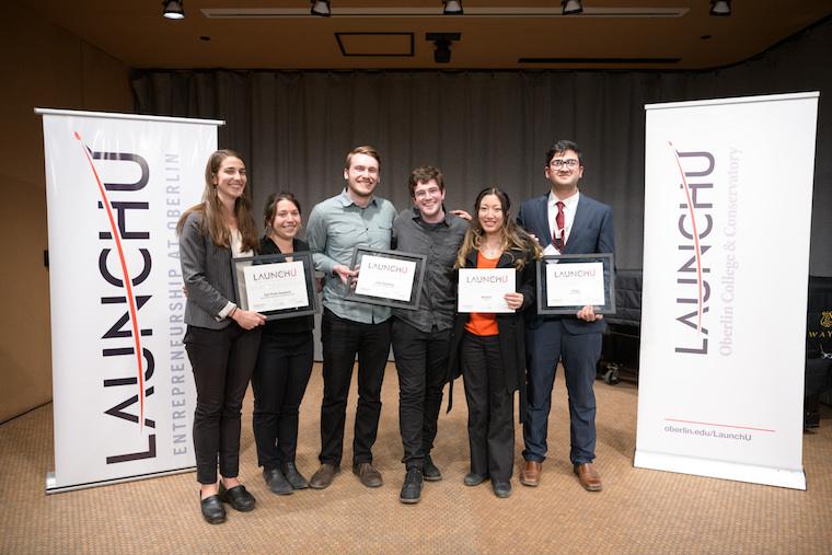 Six proud winners hold their award certificates