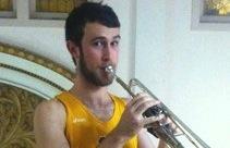 An athlete plays a trumpet