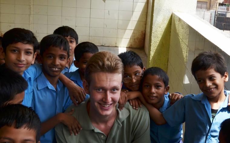 team member and rising junior Thomas Kreek with young students in New Delhi
