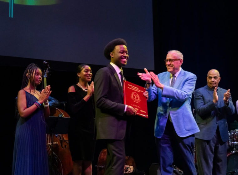 Tyreek McDole accepting his first prize award on stage