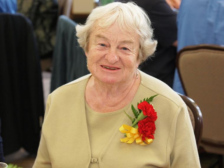 Midge Brittingham sitting at reception for Commencement Reunion Weekend.