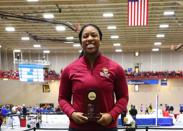 Monique Newton holding an NCAA trophy.