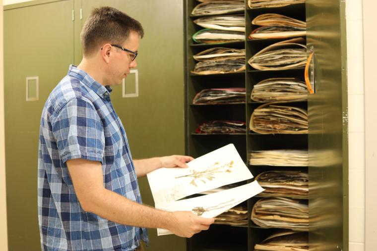Professor Michael Moore holding plant specimens