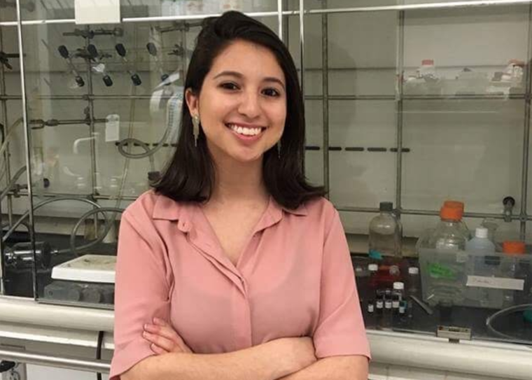 smiling woman standing in a science lab