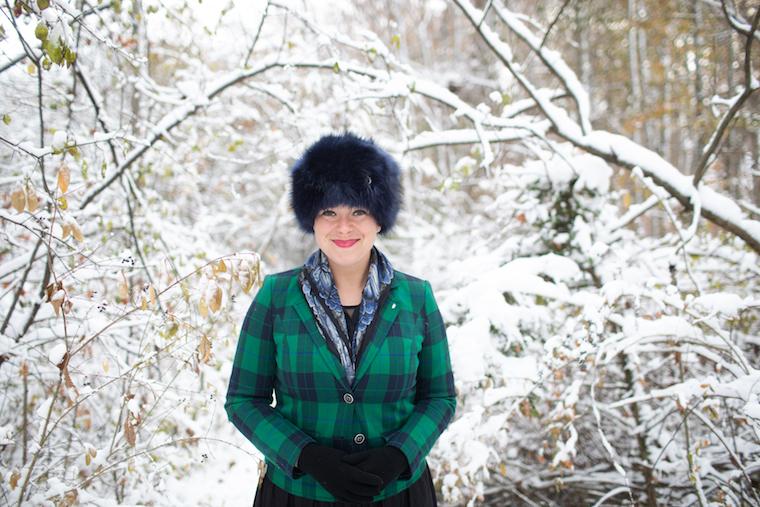 Woman standing in a snow-covered field.