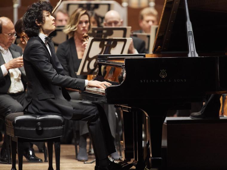 student musician playing the piano