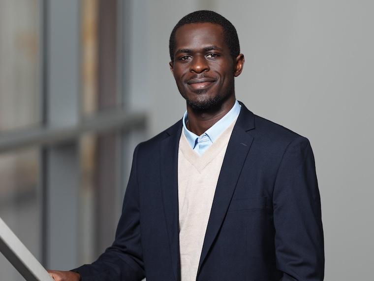 Person in blazer poses for camera.