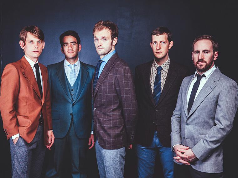 Five men in colorful suits