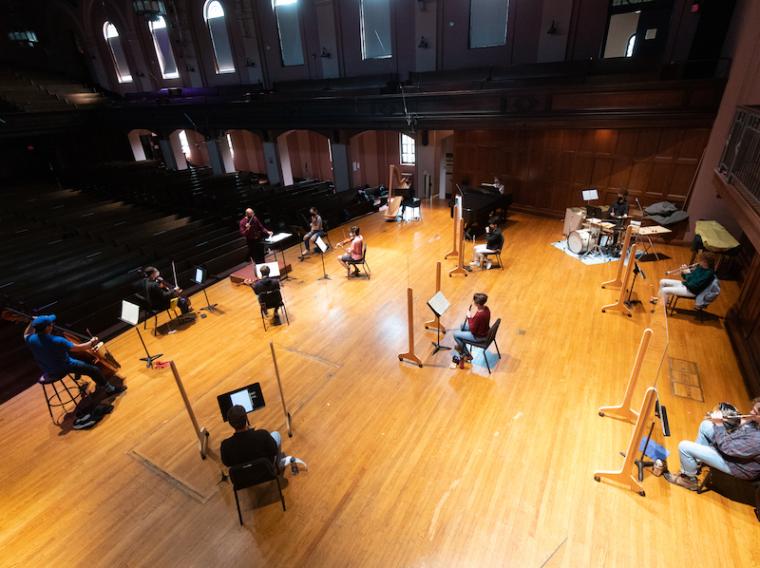 socially distanced student musicians rehearsing together
