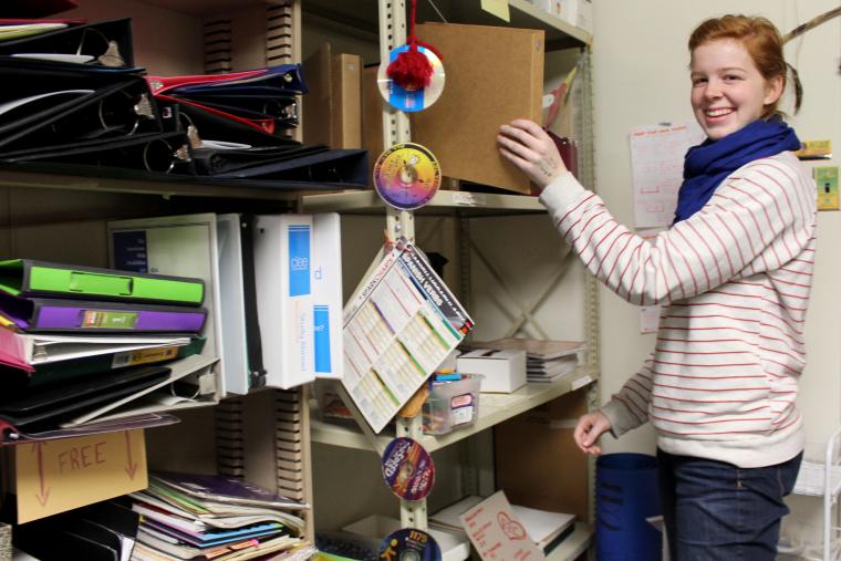 Rosalie Eck places a binder onto a crowded shelf.