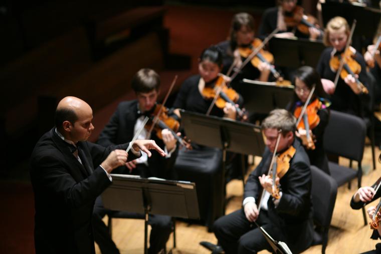 Conductor leading orchestra.