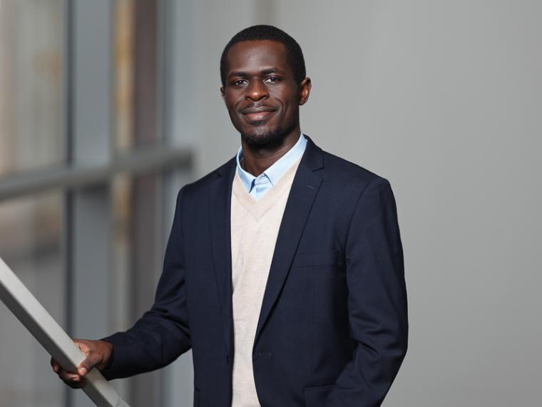 Portrait of a student in a suit smiling