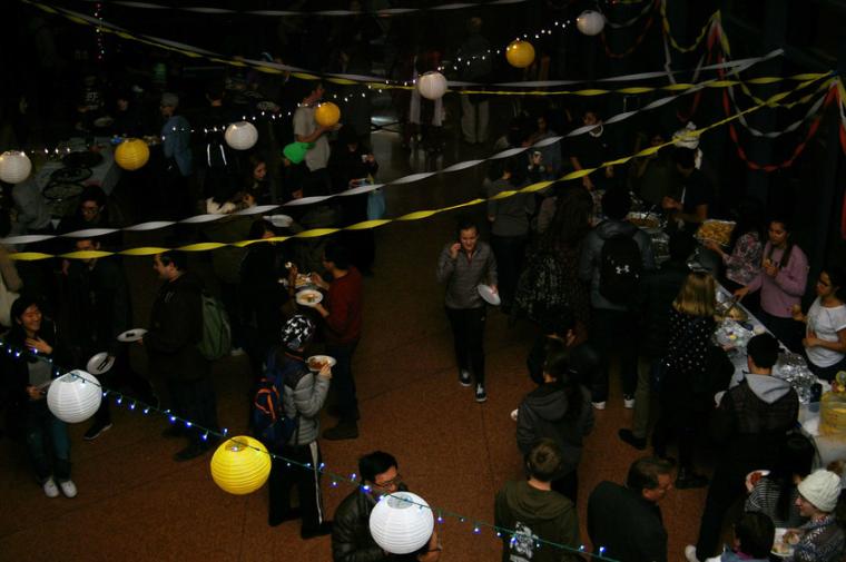 Overhead view of people walking and eating under streamers and Chinese lanterns
