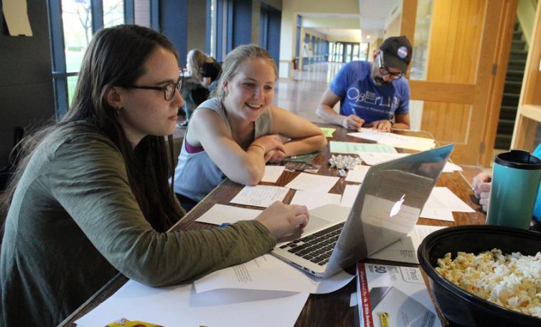 Participants of the March for Science working at a laptop in the Science Center 