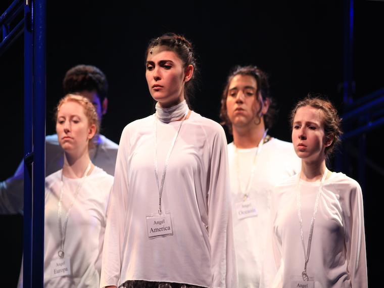 four people in white shirts who are part of Angels in America play