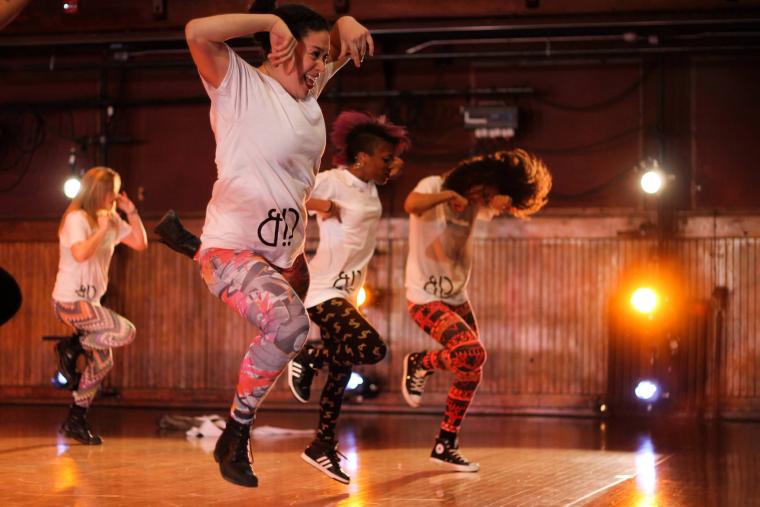 4 dancers perform wearing bright colors
