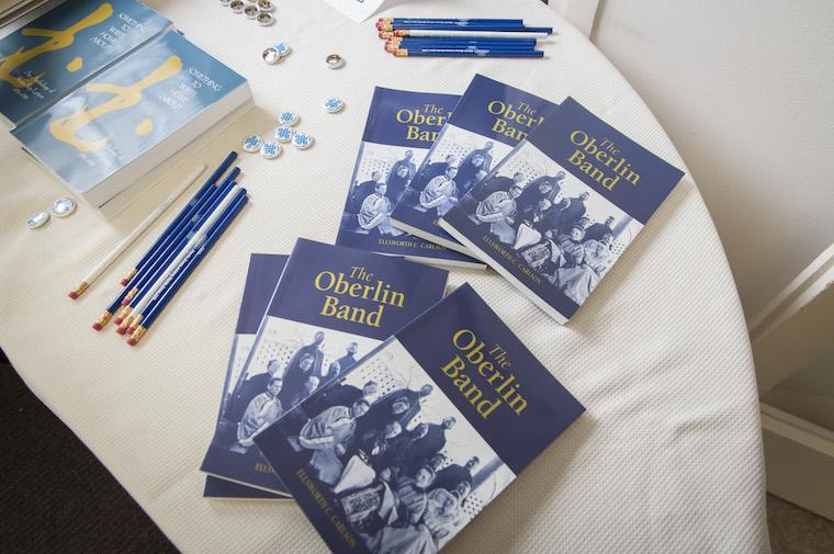 Photo of materials distributed on a table (pencils, buttons, books)