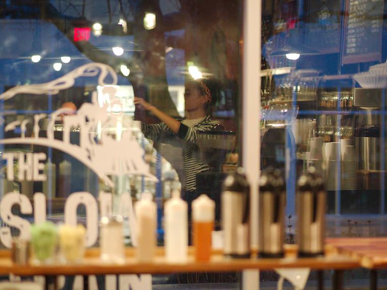 A coffee barista working behind a counter