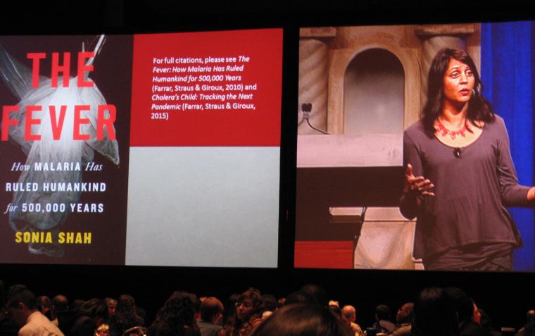 Sonia Shah with a screen showing the cover of her book, The Fever: How Malaria Has Ruled Humankind for 500,000 Years