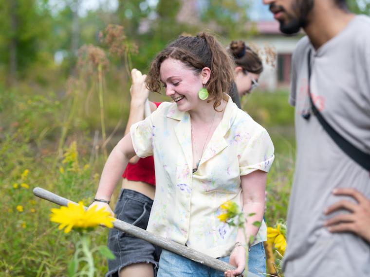 Students cheerfully tending to a garden.