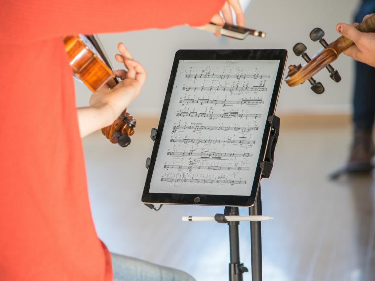 Student playing with iPad sheet music