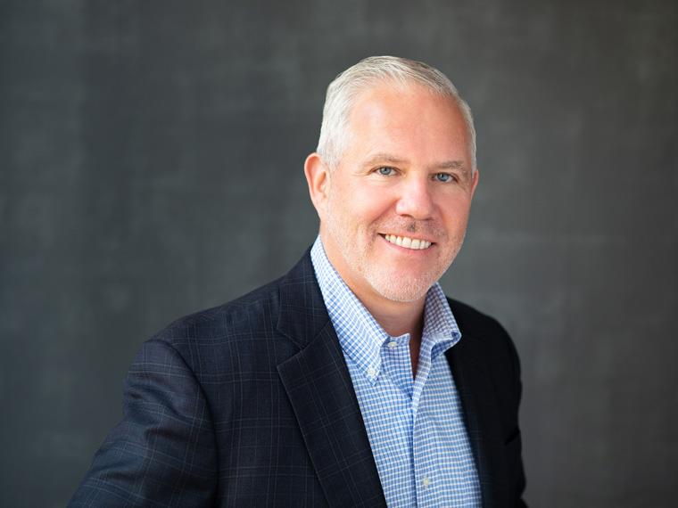 Thomas Schiltz gray haired man in blue jacket and blue plaid shirt.