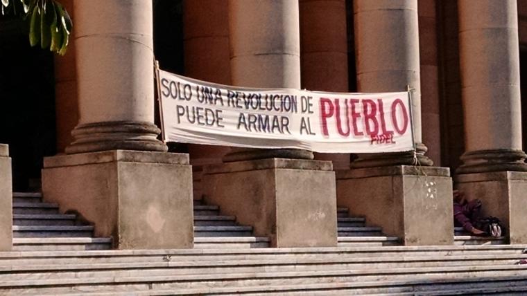 A sign hangs outside of a building at the University of Havana 