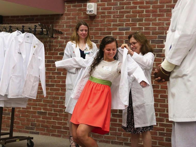 student putting on lab coat
